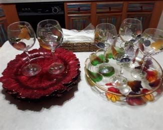 Colorful painted glasses, tray, and red chargers.