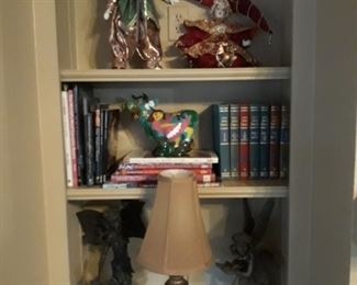 Garden art, lamp, books, and china dolls.