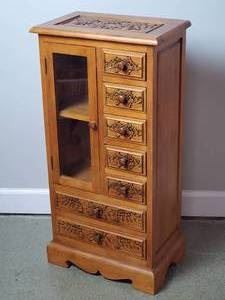 Ornate Wooden Cabinet with 7 drawers.  Features a fun carved detailed design. Could be used in the bedroom for jewelry or many other uses. 17" W x 11" Deep x 34" H