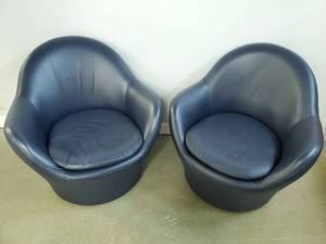 Pair of Leather Contemporary Swivel Barrel Chairs by Felix- American Leather Feliz Sitting Chairs.  One chair has superficial scraps as pictured that can be reconditioned.  34" W x 32" deep x 34" H

These chairs retail for over $1,500 each. This pair is in very good condition and very comfortable. 