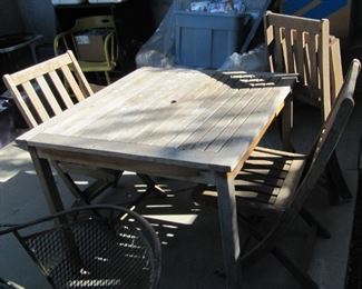 Teak table and four folding chairs