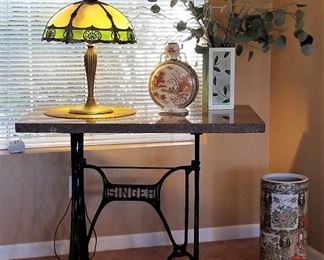 Antique stained glass lamp and singer sewing machine stand and granite top.