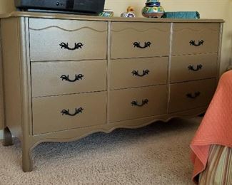 This vintage dresser  with 9 drawers matches the side night table.