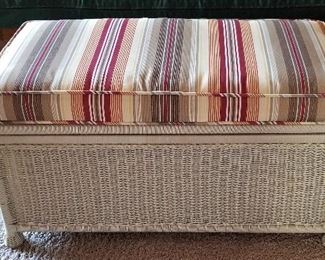 Wicker trunk that opens for storage. Great for extra seating.