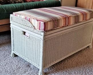 Wicker trunk that opens for storage. Great for extra seating.