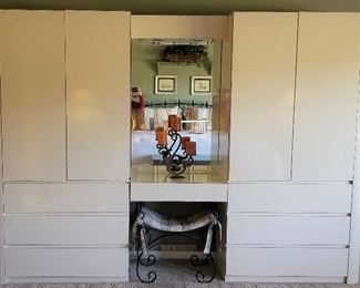 White storage units with drawers that are lighted.