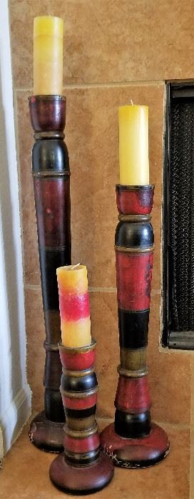 Trio of red and black candle holders.