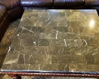 Black and white veined marble topped square coffee table.