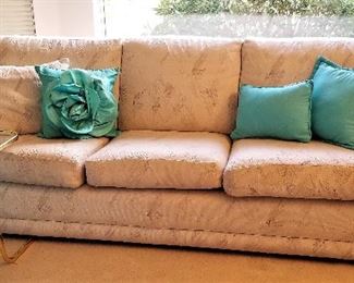Neutral sofa that has a matching loveseat.