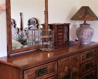 Vintage wood dresser that matches the bed. Really cool mirror that is part of the dresser that moves forward and backward.