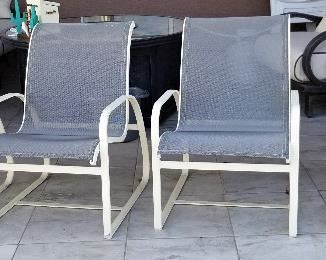 4 matching weatherproof outdoor chairs.