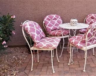 Patio table and chairs and cushions.