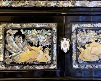 Close up view of the Oriental black lacquer mother of pearl inlay furniture.