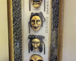 Oriental masks in a shadow box.