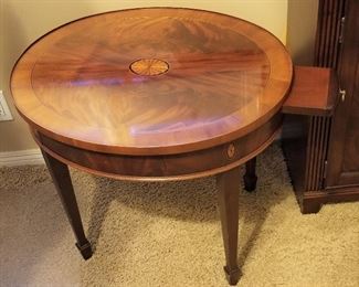 Oval side table with pull out tray for the side of a chair, sofa, or bed. It matches the tall console table.