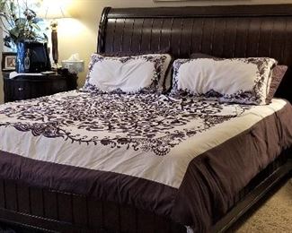 Beautiful rich dark brown king sleigh bed. Comforter set for sale too. There are 2 matching side tables that can be used at the bedside or in the livingroom as they are at a great higher height.
