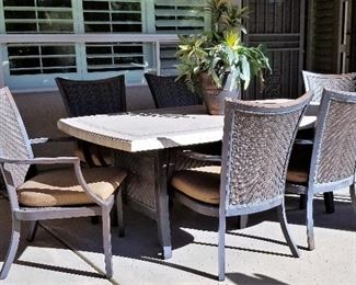 Patio stone top table and 6 chairs. The patio table has an opening if you want for an umbrella or hide the opening with the provided matching plug.