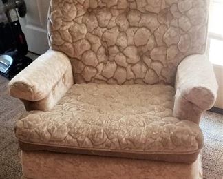 Unusual tufted cream colored chair.