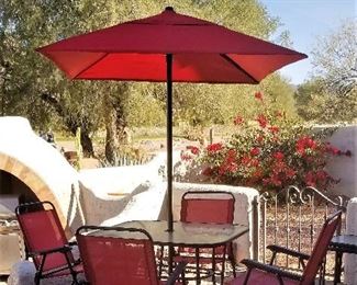 Red umbrella and red chairs. Not too big. 