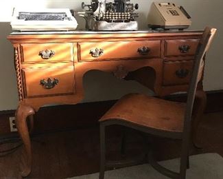 Lovely desk with glass top, old school chair, vintage typewriters, adding machine