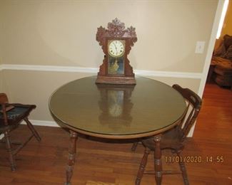 Table and 4 Chairs.   The clock was removed from the sale.