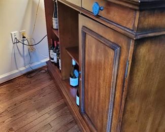 Back of bar showing closed cabinet and open shelf storage