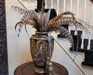 Ornate urn depicting dancing figures with feather bouquet and tassels - 18" tall x 12" diameter