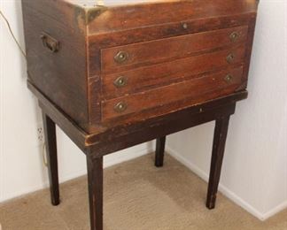 87. $350.00. Antique silver chest on stand. Name plate: Scolfield March 2, 1911. 37.5” X 27” X 20”