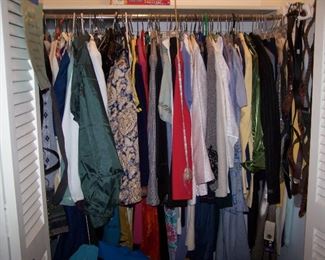 A VIEW OF ONE OF THE SEVERAL CLOSETS FULL OF CLOTHING--SOME NEVER WORN--STILL HAVE TAGS!
