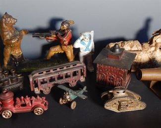 A large collection of antique cast iron banks and toys.