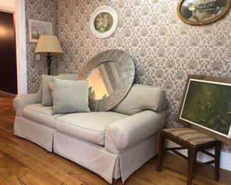 Floor lamp, small couch, decorative wall mirror