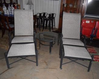 2 lounge chairs with foot rest and table