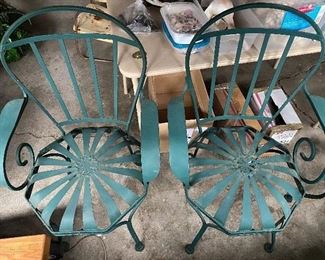 $110.00 pair of Pinwheel/sunburst metal Patio chairs after Francois Carre.  One chair has a seat band detached, but it's not missing...just needs some TLC