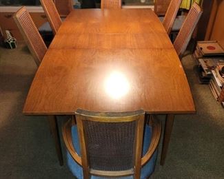 Lane MCM dining room table with eight chairs. 60" long x 40"w in the middle (36"w on the ends because the table tapers at each end.) There are 3 12" leafs, 96" total length with leafs. There is a buffet cabinet and china cabinet to match