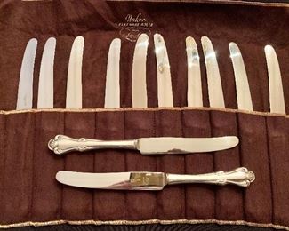 $2900; Camusso “San Marco” Sterling Silver Set; 62 PIECES; Shown: 12 dinner knives; 9.75" long.  Set includes additional 15 teaspoons, 10 salad forks, 12 dinner forks, 12 soup spoons, 1 serving spoon.  Made in Peru.