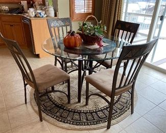 Round beveled glass table with wrought iron base; 4 chairs