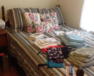 Full size bed with mattresses and bedding. Full size sheet sets