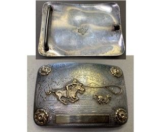 2) $400 Vintage 1955 Sterling Silver and 10K Gold Renalde Trophy Buckle. 123 grams total weight. No name is engraved on the bottom plate but is engraved Blythe Junior Rodeo ALL AROUND COWBOY 1955. Features 4 Roses in corners and Roping Scene.  Stamped Renalde Sterling Silver Denver Colorado 10K. Some scratches as shown. Measures approx 21/2 x 3 3/4 (1 of 2 views) 