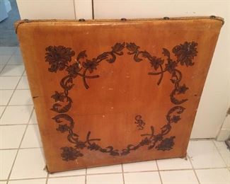 Antique card table with floral drawing.