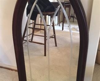 Wooden mirror in unusual shape with etching on glass.