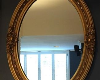 Gilded oval mirror.