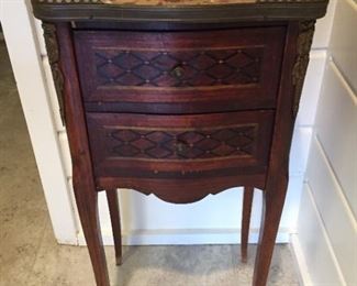 Small antique chest of drawers with marble top (cracked) and metal surround.