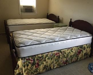 Twin beds with wooden headboards and almost new mattress and boxspring.