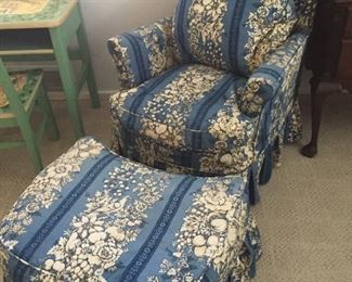 Upholstered armchair with matching ottoman.