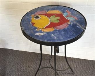 Round garden table with fish pattern.