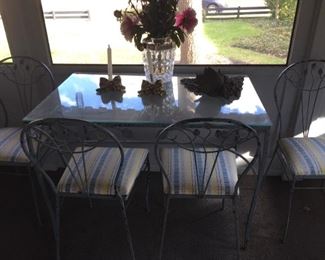Glass table with wrought iron chairs.
