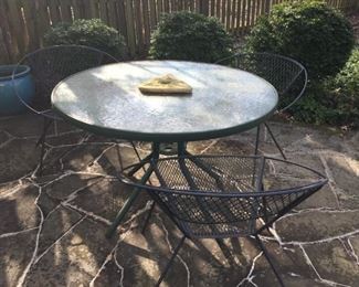 Round table with wrought iron chairs.
