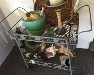 Metal cart with vases and garden items.