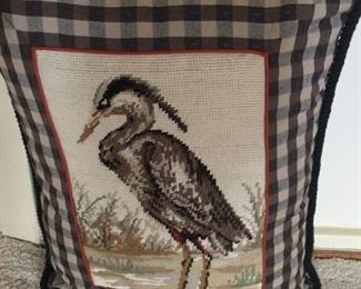 Needlepoint pillow with checked background.