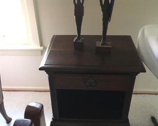 End table with carved figures.